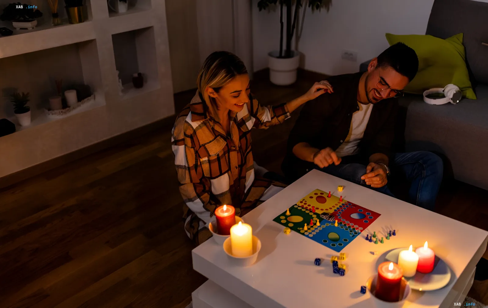 Couple playing a board game by candlelight due to power outage in Ukraine