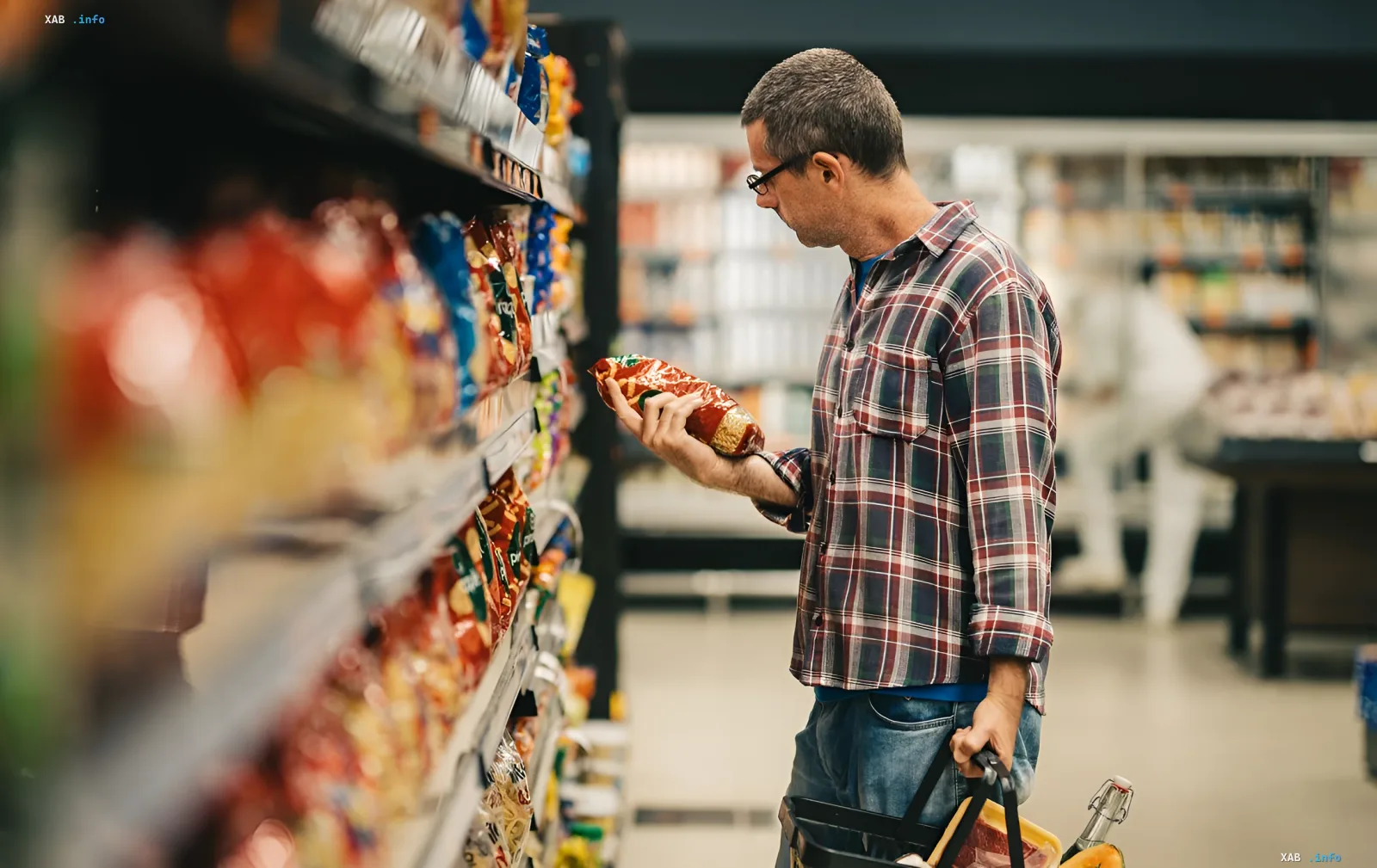A shopper in a supermarket examining a product label on the shelf, illustrating the need for product labeling