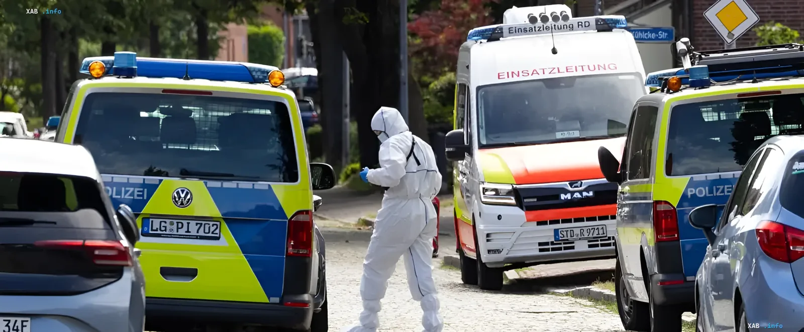 Investigators in protective suits and police vehicles at the scene of a mass murder in Stade, Germany — aftermath of tragedy at a crisis center