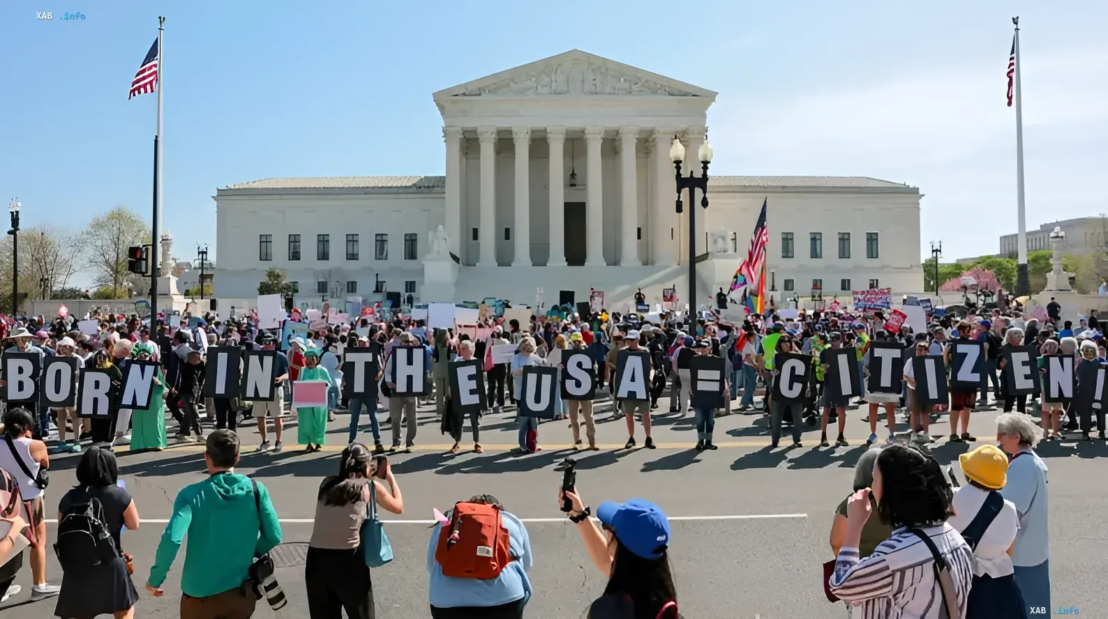 Protest in front of the US Supreme Court with signs reading 'BORN IN THE USA = CITIZEN' supporting the 14th Amendment and birthright citizenship