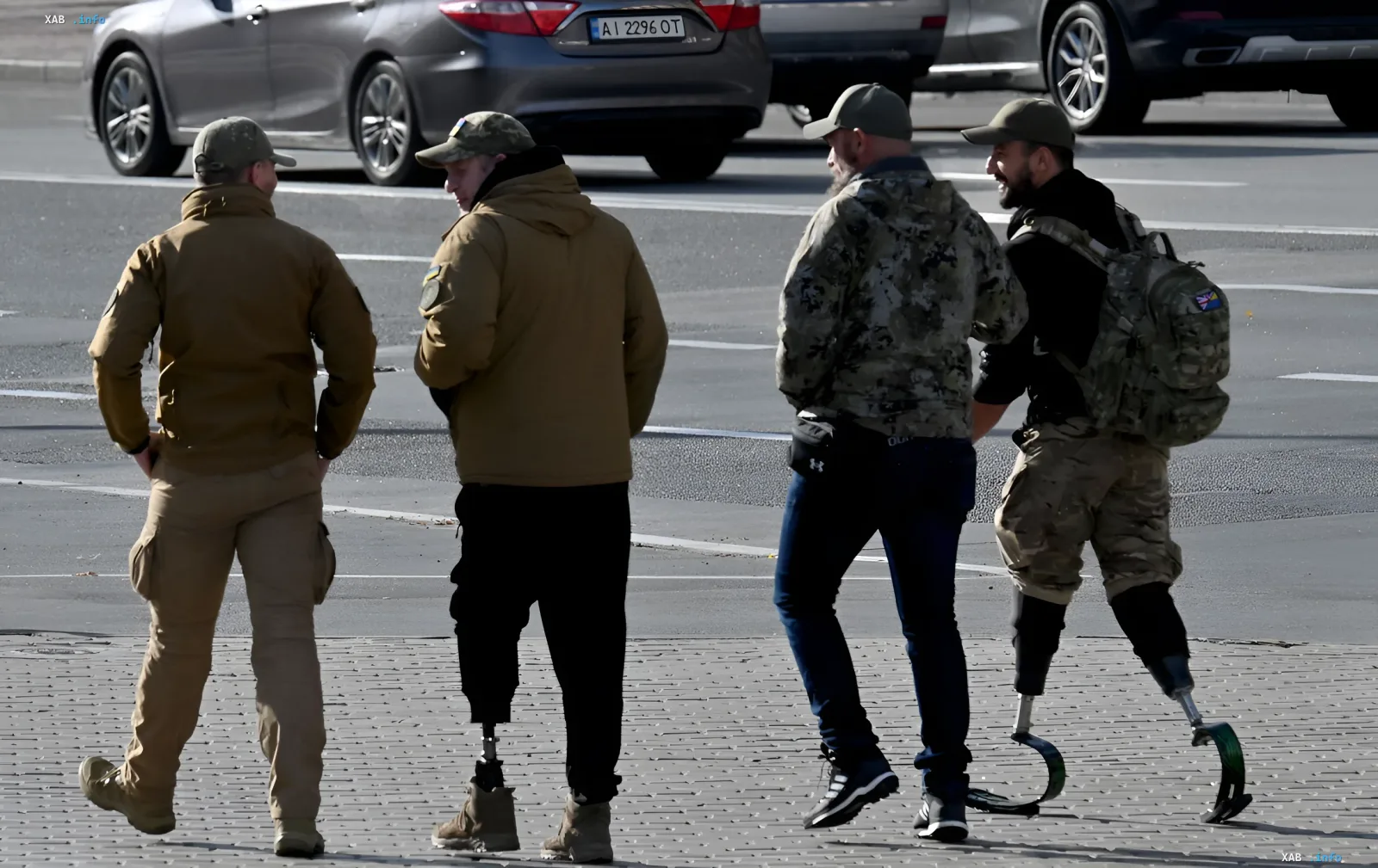 A group of Ukrainian veterans with leg prosthetics walking on a city street, symbolizing the need for adaptation and support for combat veterans with disabilities