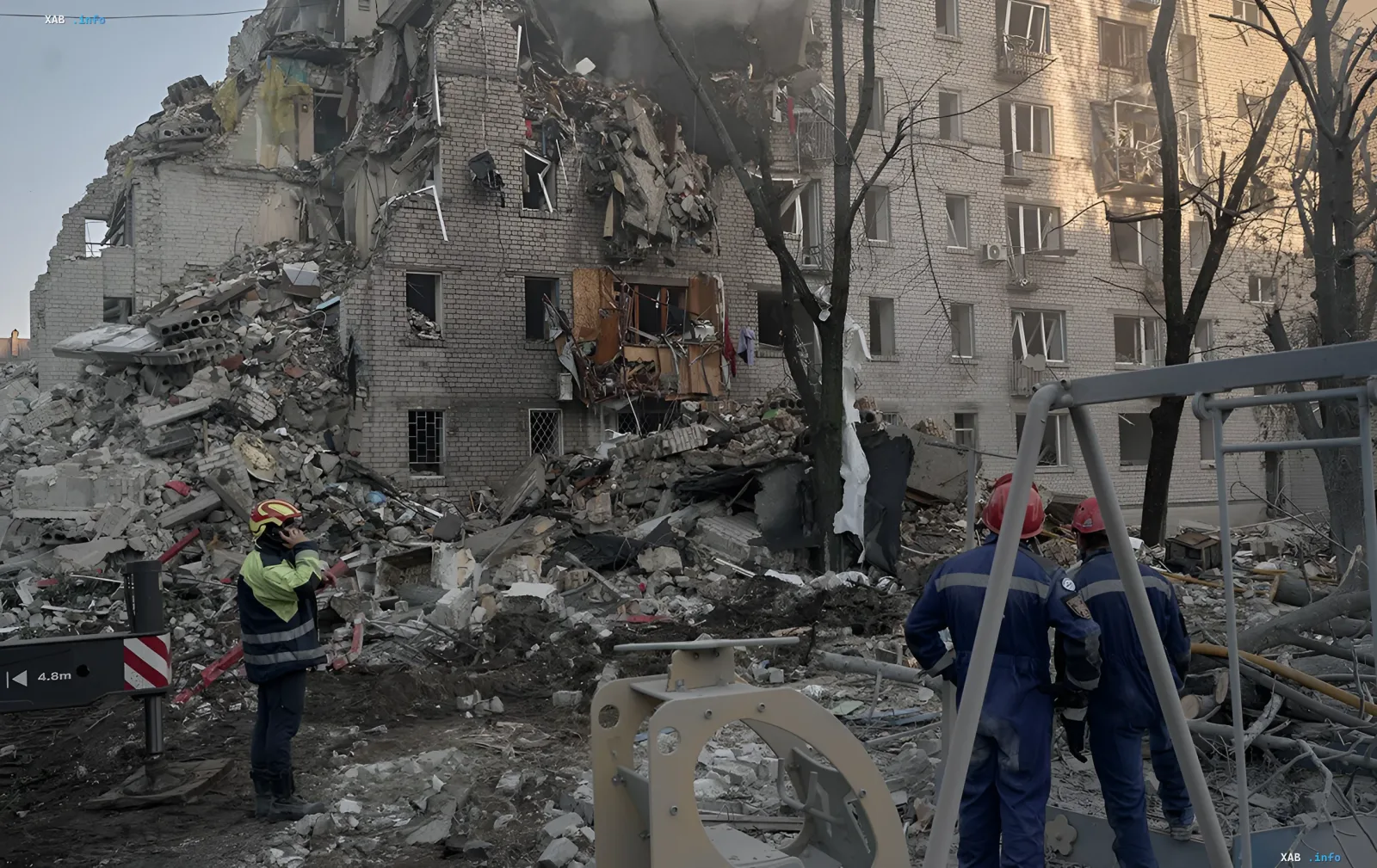 Rescuers in protective gear inspect a destroyed building after a missile attack in Kyiv, searching for victims under the rubble