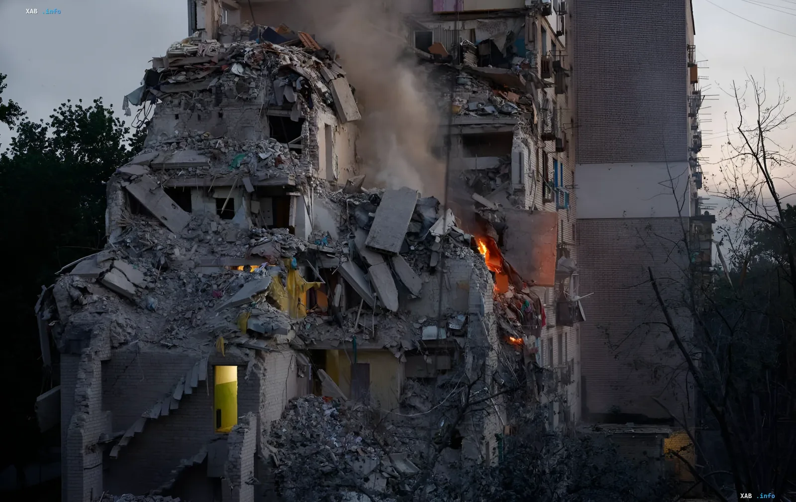 Destroyed residential building in Kyiv after a massive attack, fire and smoke from windows, aftermath of strikes on Ukraine's capital