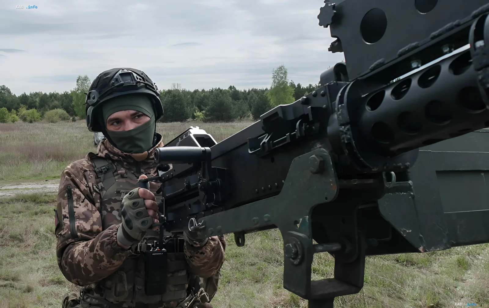 Soldier in camouflage near heavy machine gun in field — symbol of defensive actions during massive attack on Kyiv