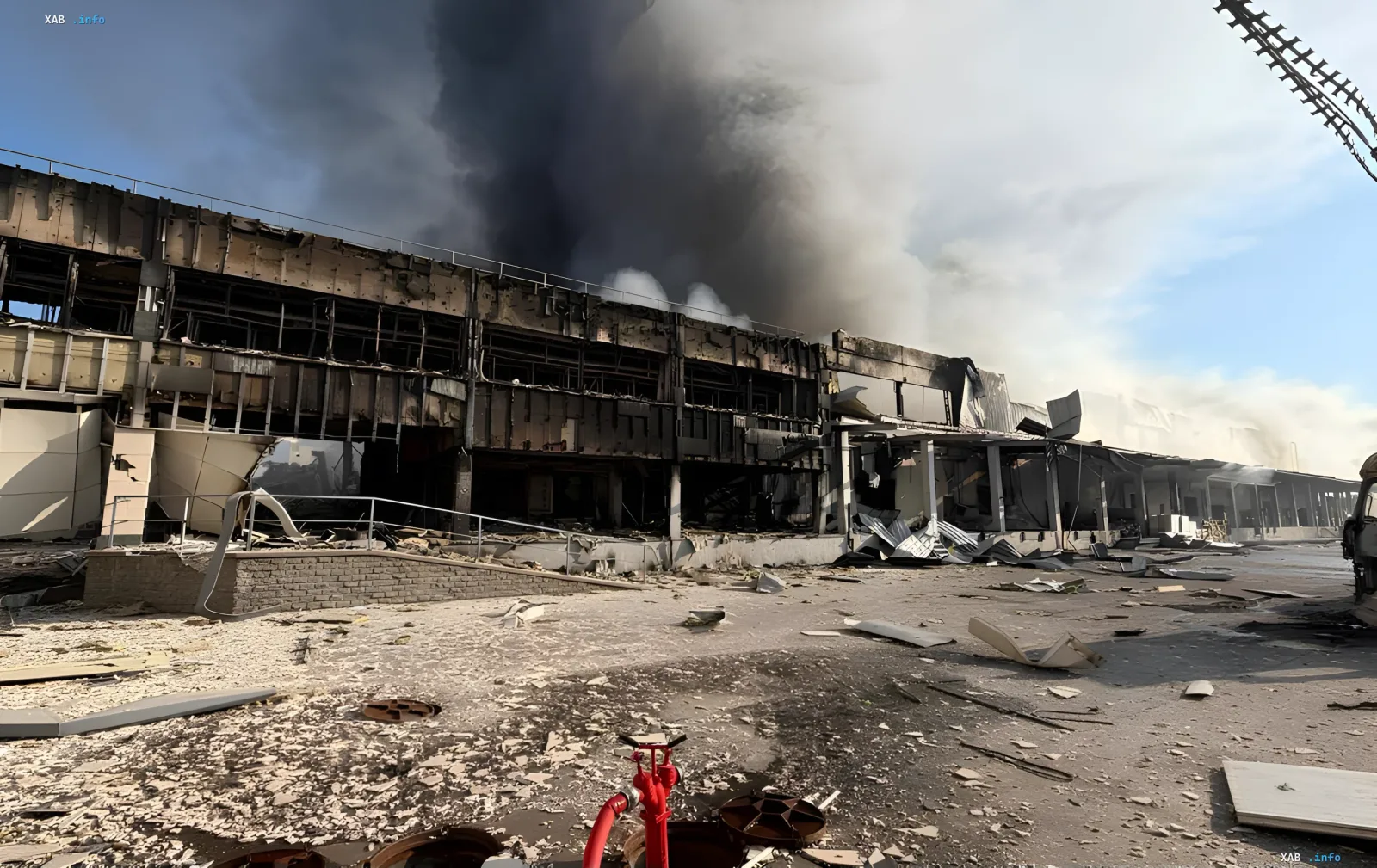 Destroyed MOYO warehouse in Kyiv after night rocket attack: burnt building with smoke and debris on site