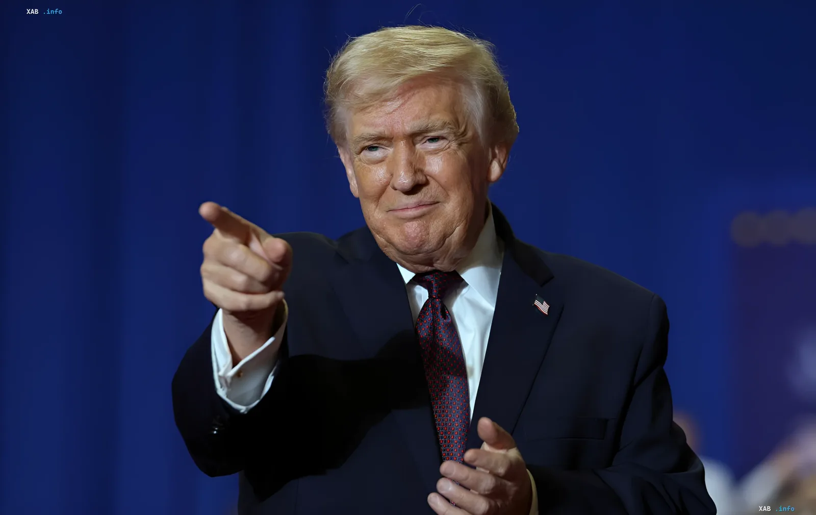 Donald Trump pointing during a speech, discussing negotiations with Iran on nuclear program and threat to Strait of Hormuz