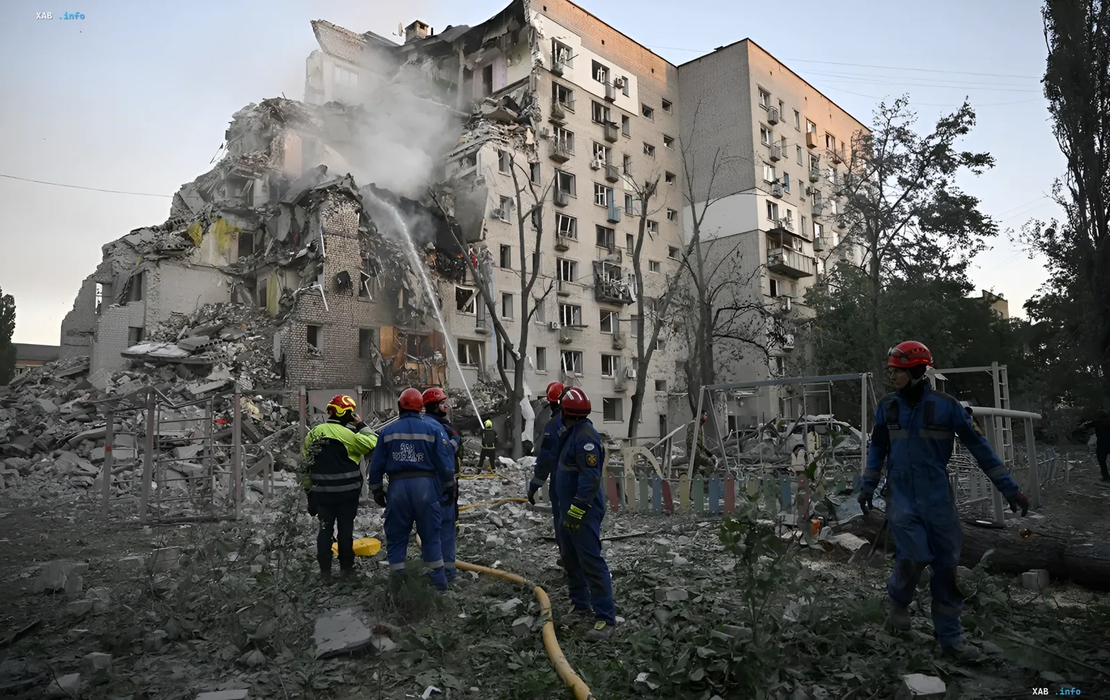 Firefighters extinguishing a fire in a destroyed building in Darnytskyi district of Kyiv after an attack