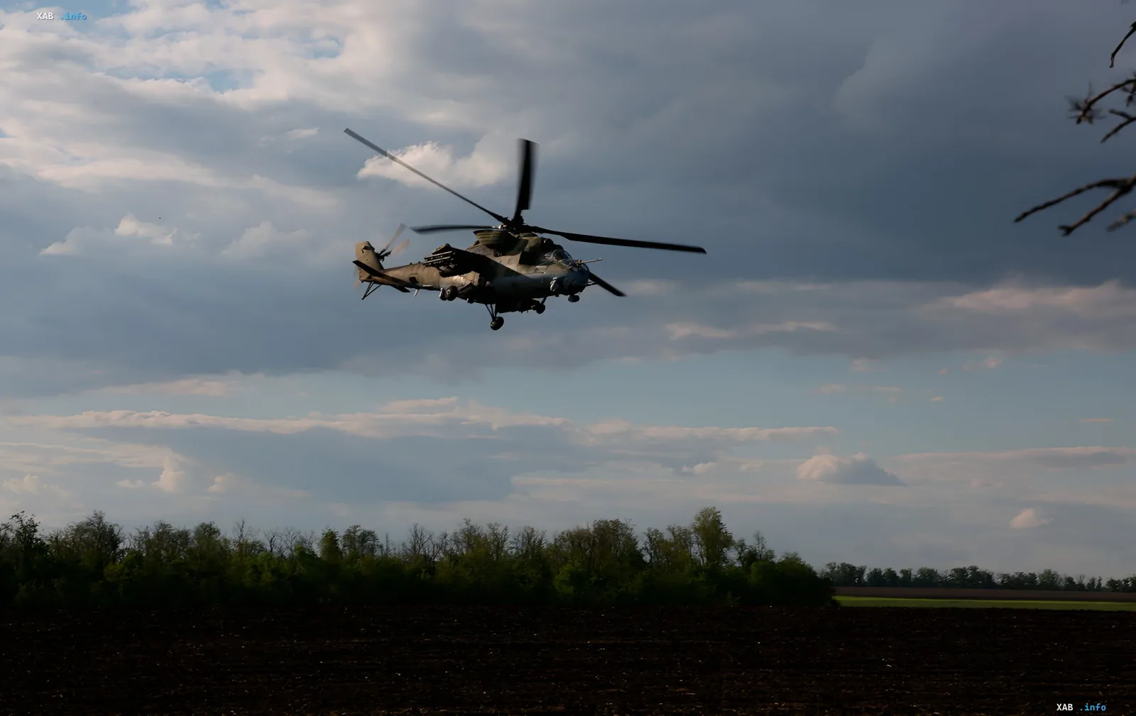 Military Mi-24 helicopter flying over a field, symbolizing the strengthening of air defense and new supplies in Odesa
