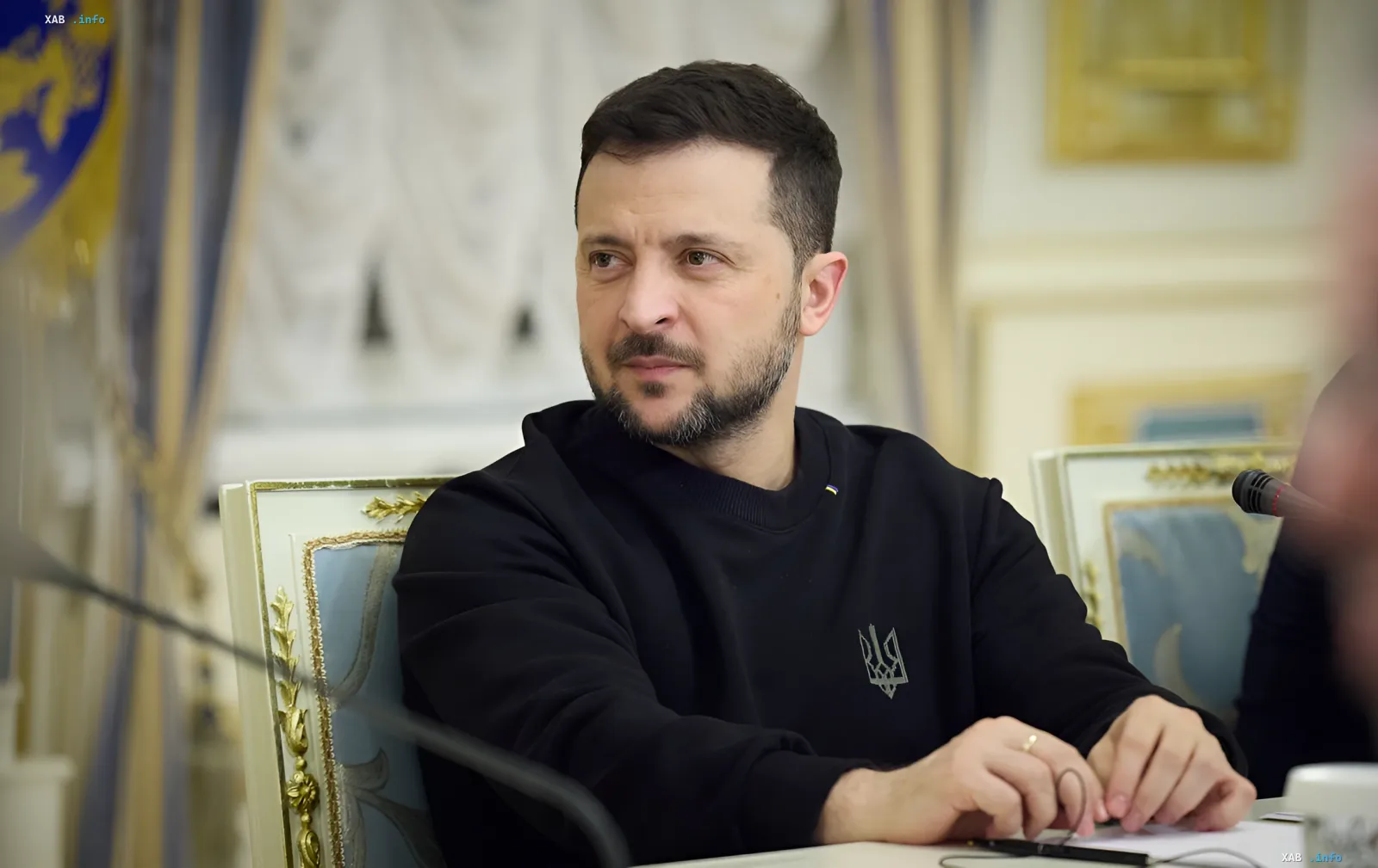 Ukrainian President Volodymyr Zelenskyy in a black sweatshirt with trident emblem during a meeting discussing Russian fleet losses in the Black Sea and creation of new academy