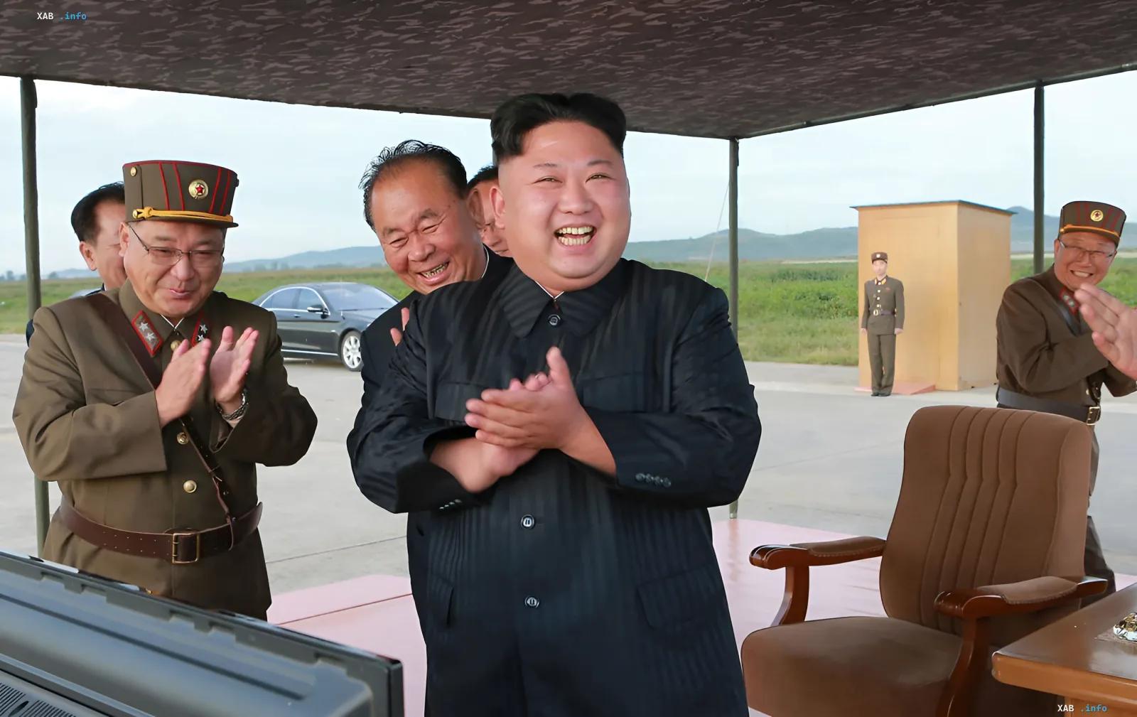 Kim Jong Un smiles while observing the launch of North Korea’s new destroyer, clapping alongside military officials at a test range