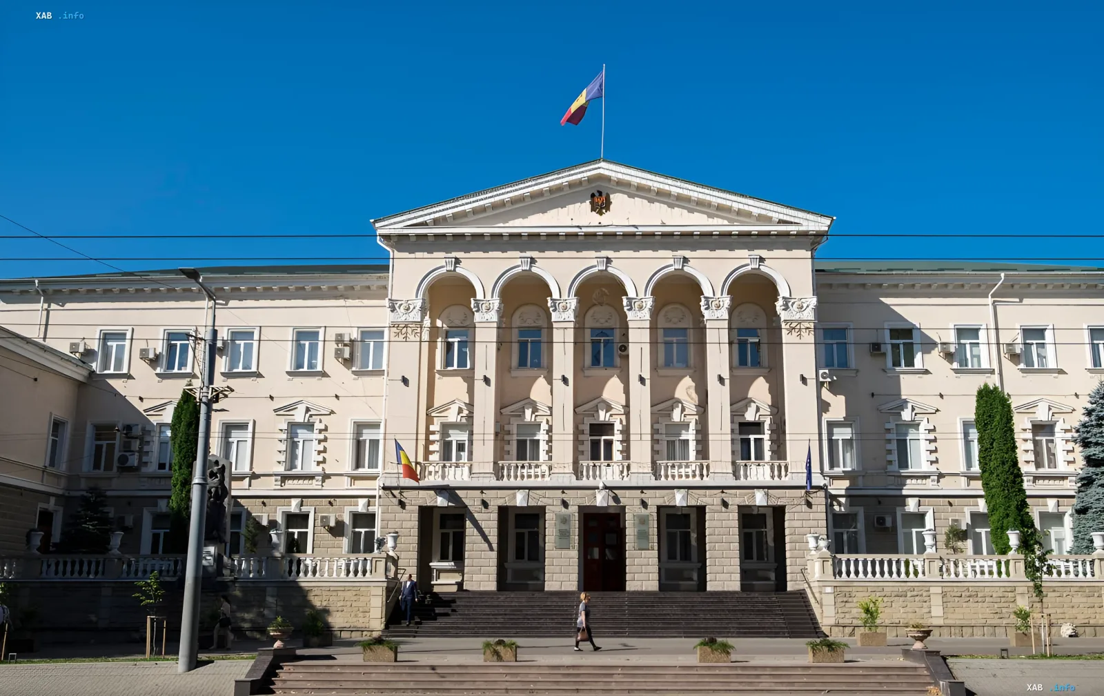 The Russian House building in Chisinau with the Moldovan flag against a clear sky — a symbol of the cultural center set to close