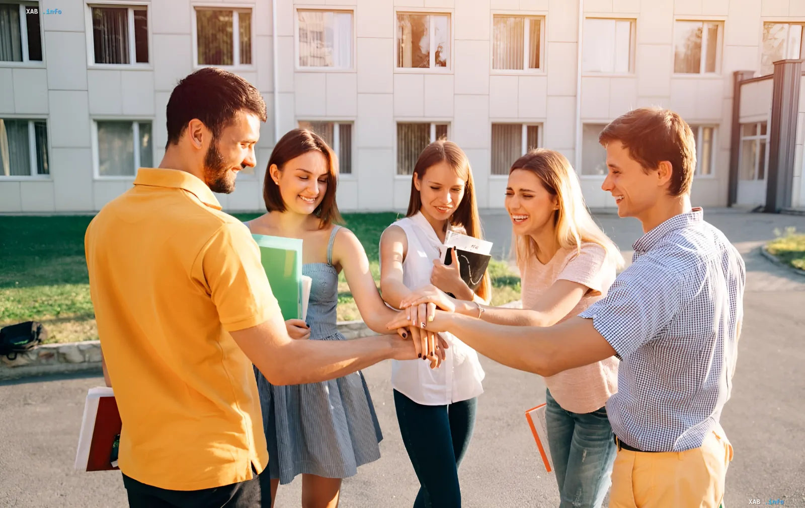 Group of students joining hands in the center, symbolizing teamwork and support in the context of admission-2024 and competitive score formation