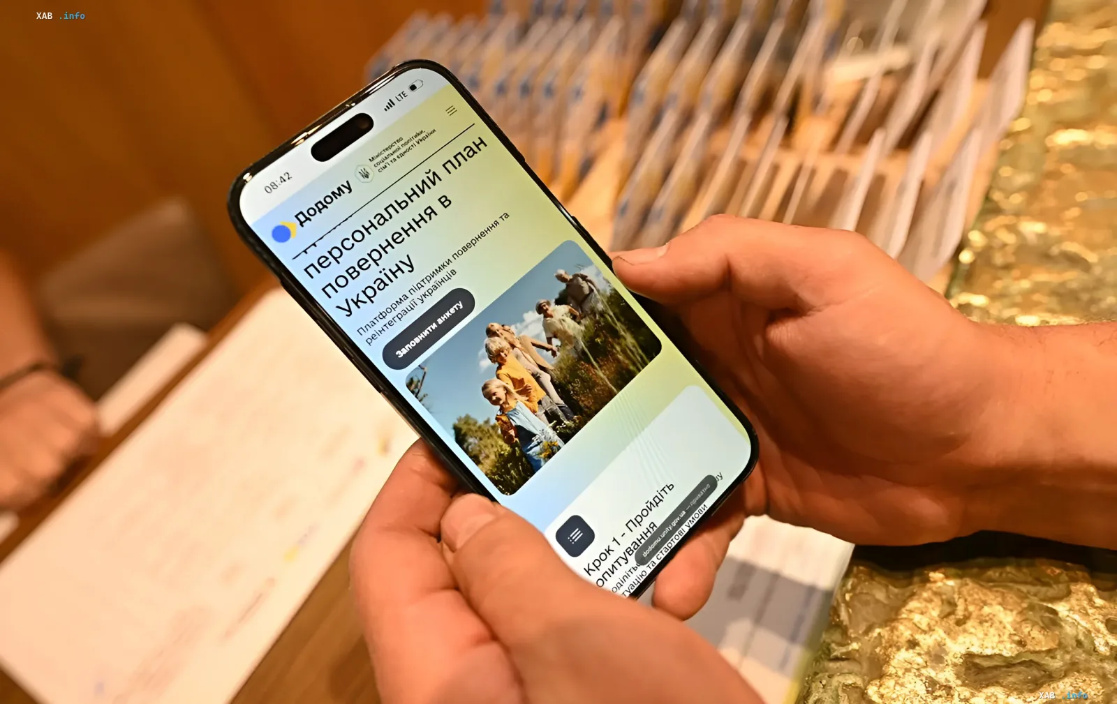 Person holding a smartphone displaying the 'Dodomu' app — Ukraine’s official platform for personalized return plans for Ukrainians abroad