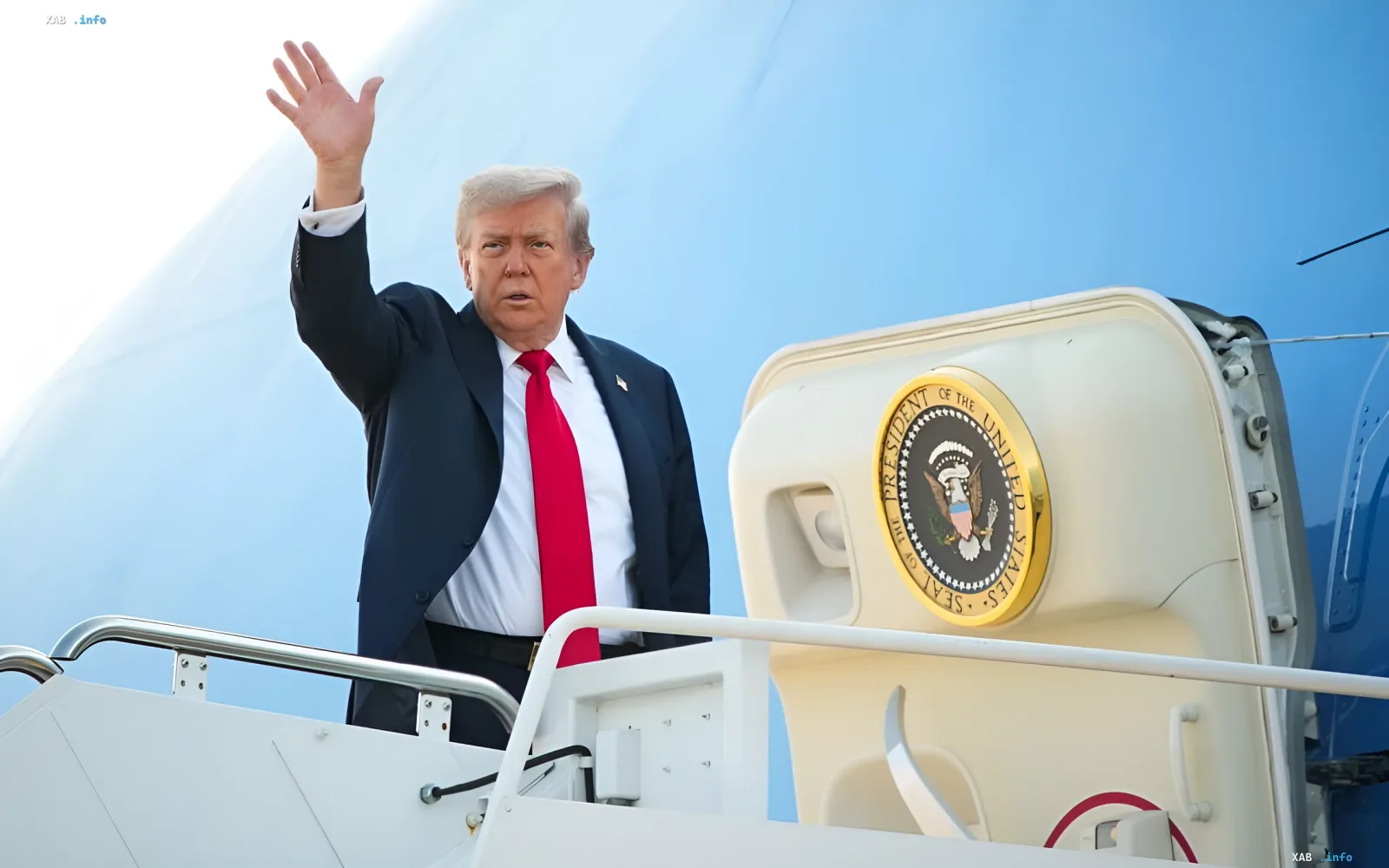 Donald Trump waves from the stairs of a plane with the US presidential seal against a blue sky, symbolizing the connection to the Trump-named airport in Palm Beach