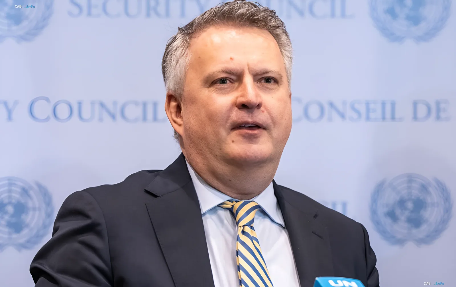 Sergey Kislica in front of the UN Security Council logo, discussing details of the failed peace negotiations