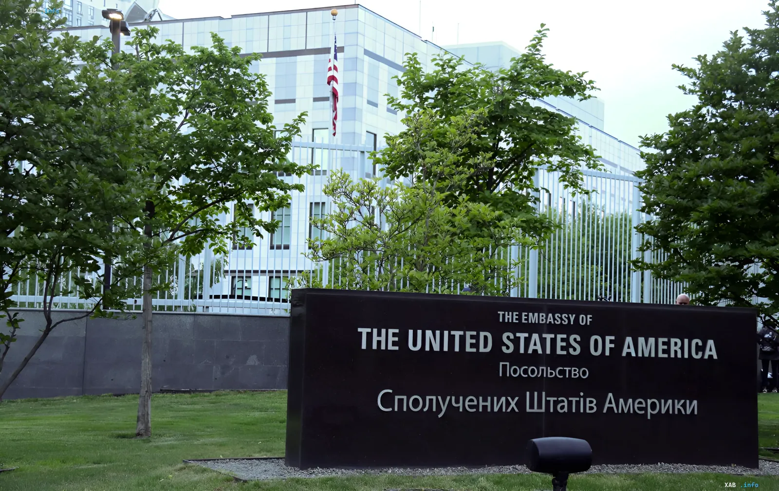 Facade of the US Embassy in Kyiv with the American flag and a sign in English and Ukrainian