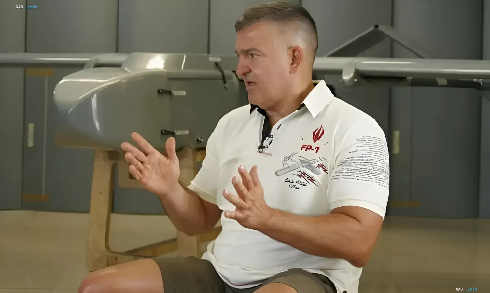 Developer of the Ukrainian FP-7 drone explains project details in front of a drone model