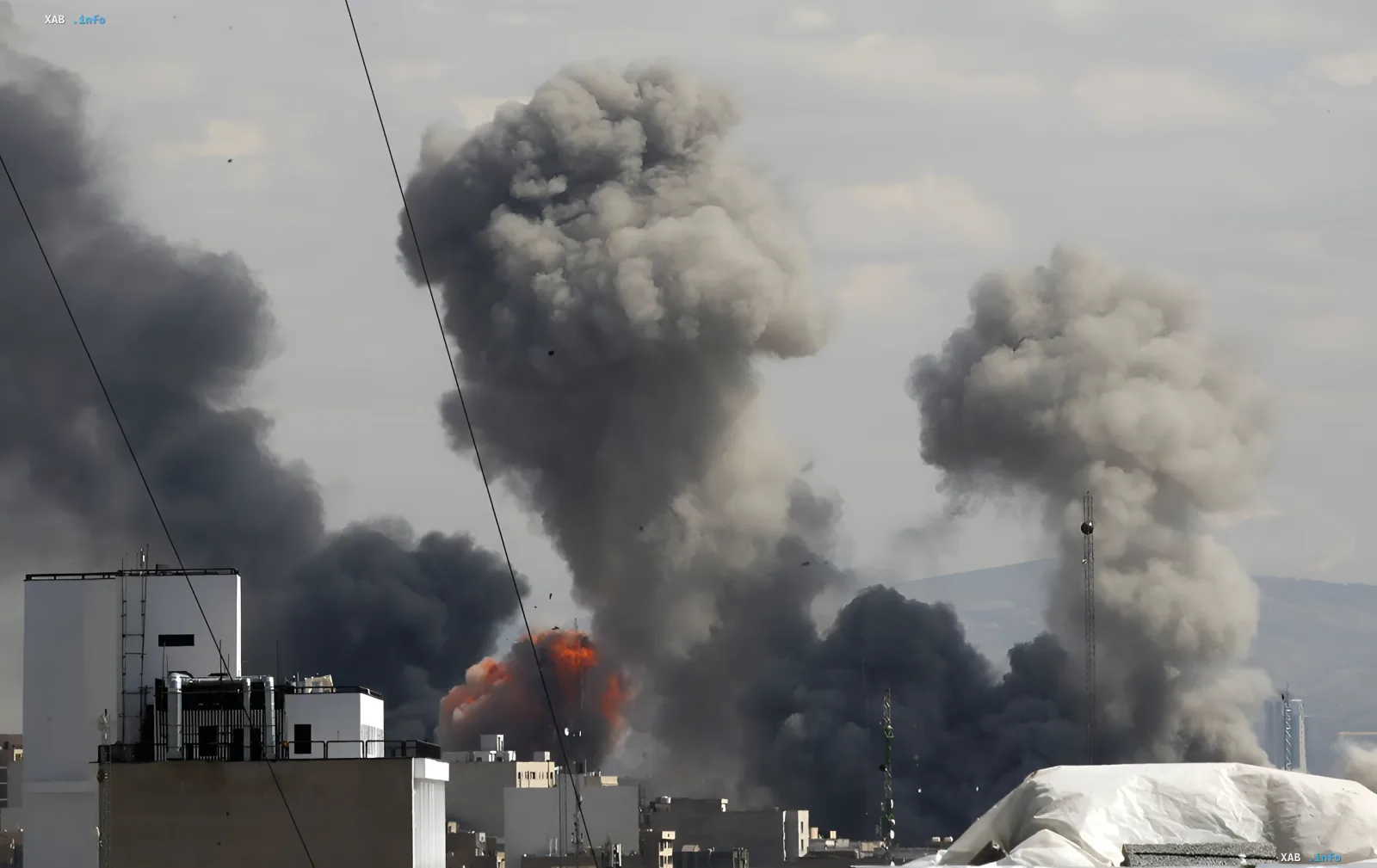 Massive explosion and thick black smoke over a city following US strike on key Iranian railway bridge