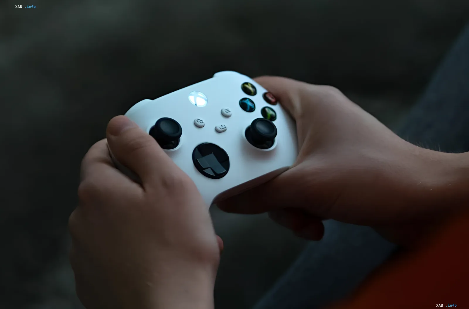 Gamer's hands holding a white Xbox controller, symbolizing Microsoft's shift in gaming subscription strategy
