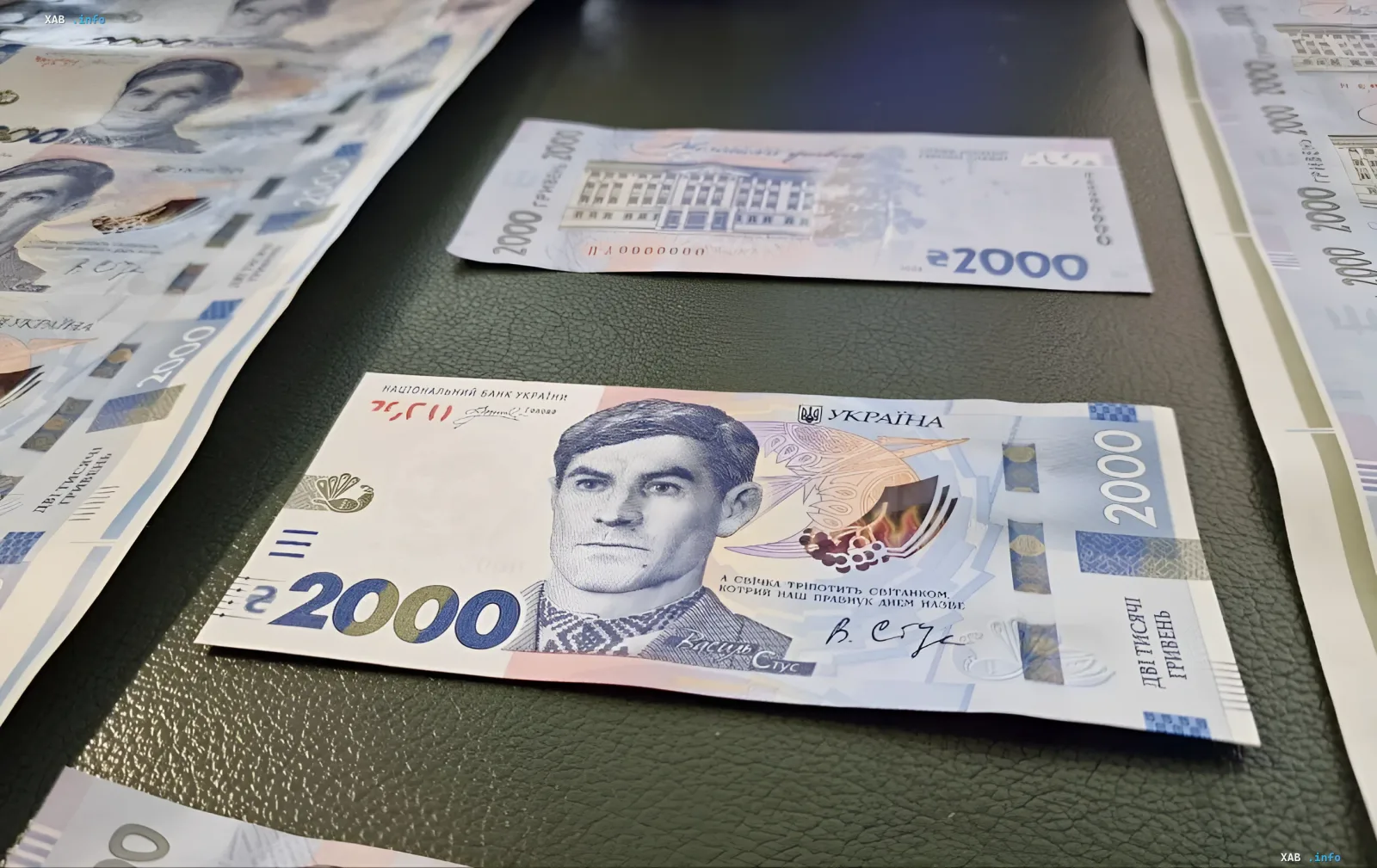 Новая купюра 2000 гривен с портретом украинского поэта и диссидента Василия Стуса, лежащая на столе среди других банкнот