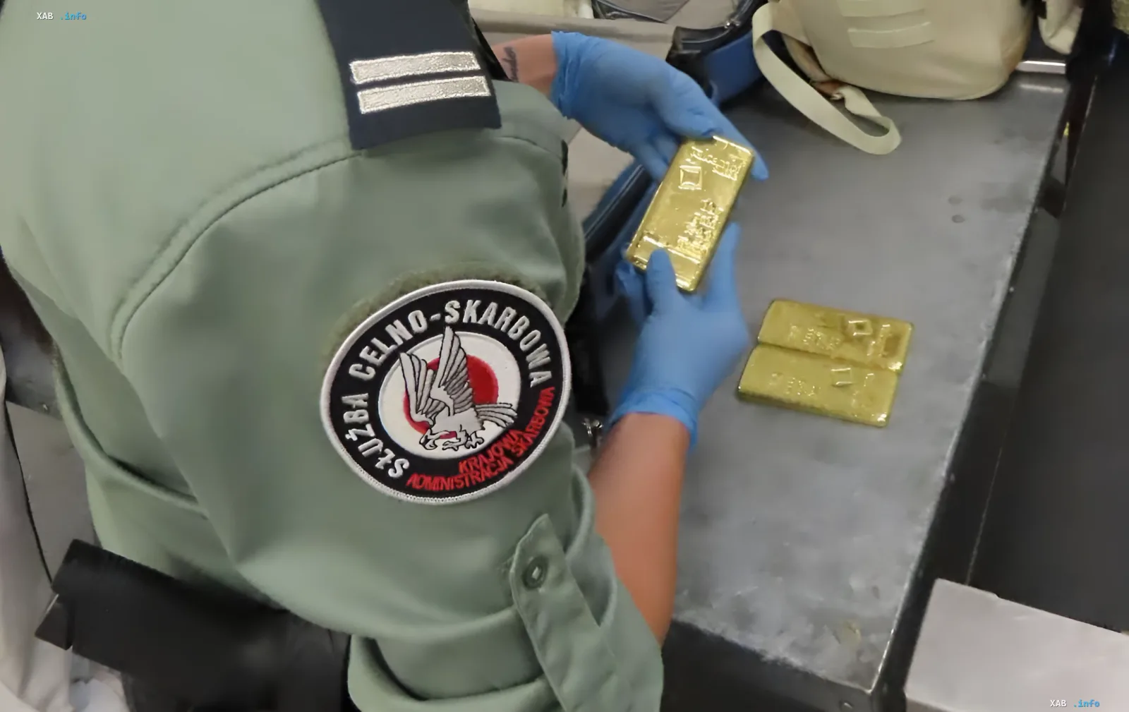 Polish customs officers inspect gold bars seized from a Ukrainian woman attempting to smuggle 3 kg of gold across the border