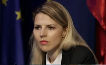 Bulgarian politician in front of EU and Bulgarian flags, symbolizing the country's shift from the 'Coalition of the Willing' to diplomacy
