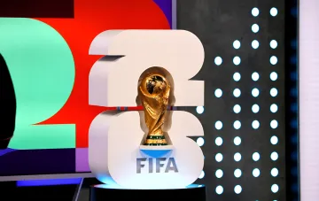 FIFA World Cup 2026 trophy displayed against the tournament logo, symbolizing the upcoming final between Spain and Argentina