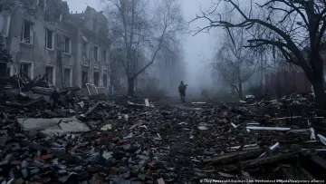 Ukrainian soldier walks through a destroyed street in Konstantynivka amidst ruins and debris