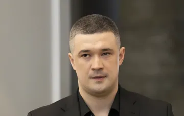 Mikhail Fedorov in a black suit against a neutral background, discussing his resignation and role in the war