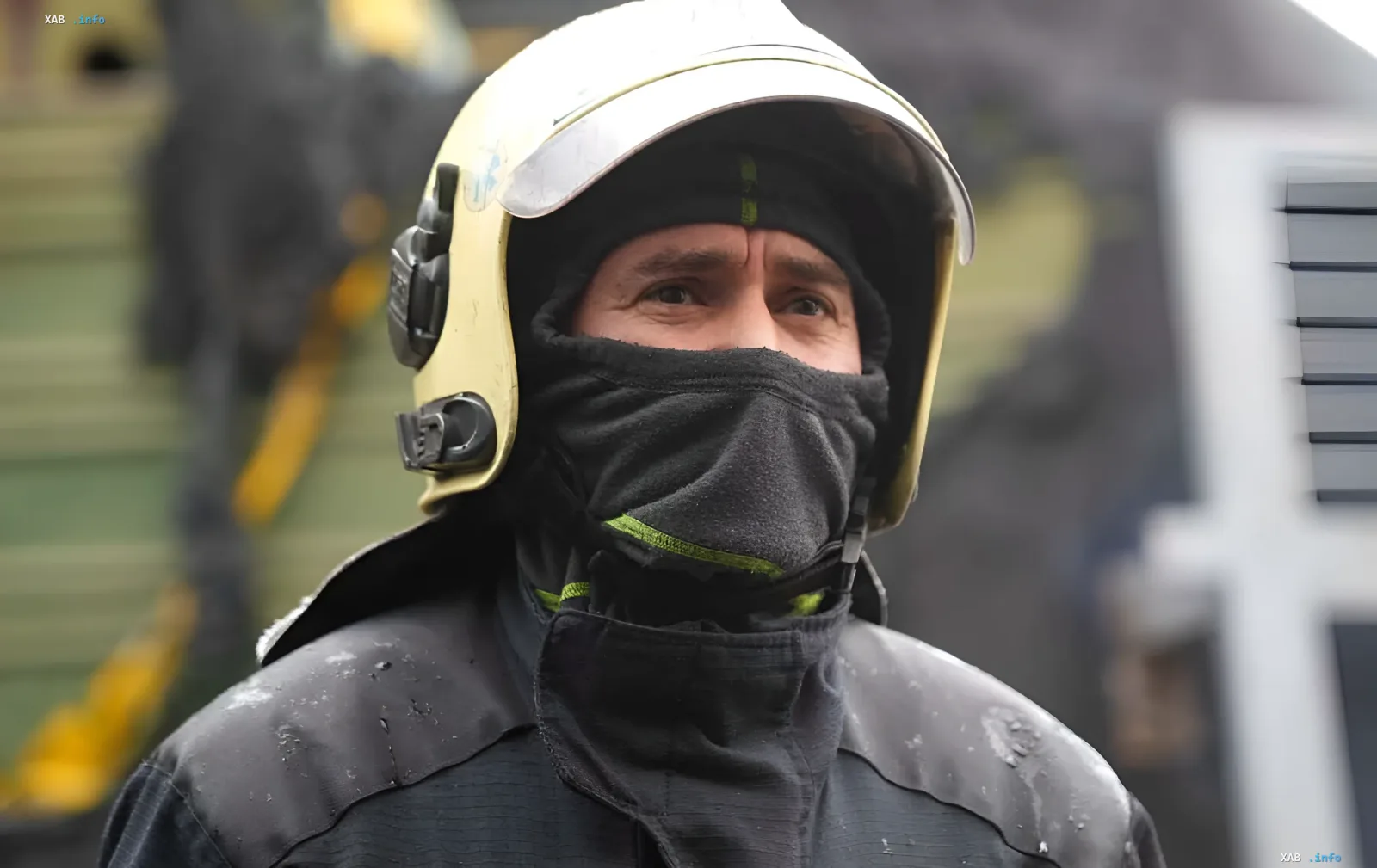 Firefighter in protective helmet and mask amidst destruction after attack on Odesa