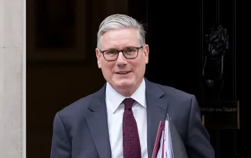 UK Defence Secretary Kevin Hollingworth exits Treasury building with documents — in context of £300M allocation for 16 modern fighter jets for Ukraine