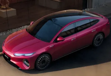 Modern red electric car with panoramic roof and digital headlights, symbolizing the growing memory consumption in the automotive industry