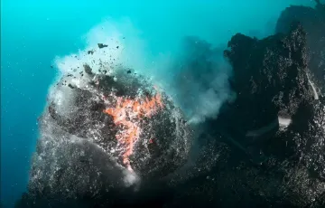 Подводное извержение вулкана: раскалённая лава пробивается сквозь морское дно, создавая облака пара и пены — момент рождения нового океанического разлома