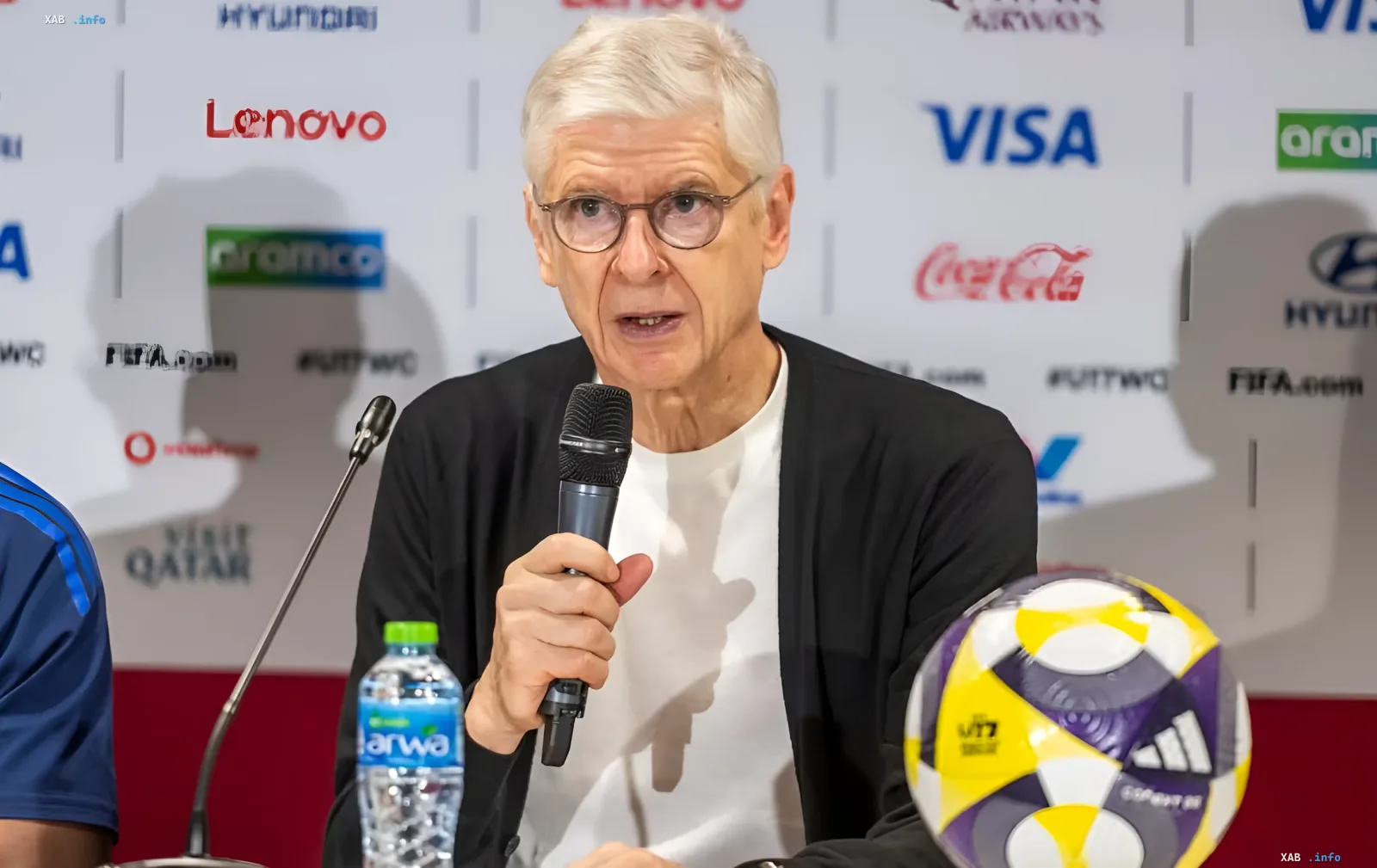 Arsene Wenger at FIFA press conference with ball and microphone, discussing hydration breaks after WC-2026