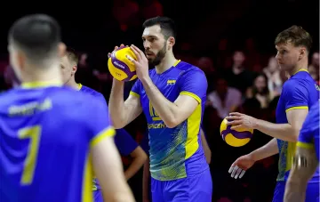 Ukraine national volleyball team players in blue and yellow uniforms with Mikasa balls, preparing for a match after dramatic rescue from Brazil’s defeat
