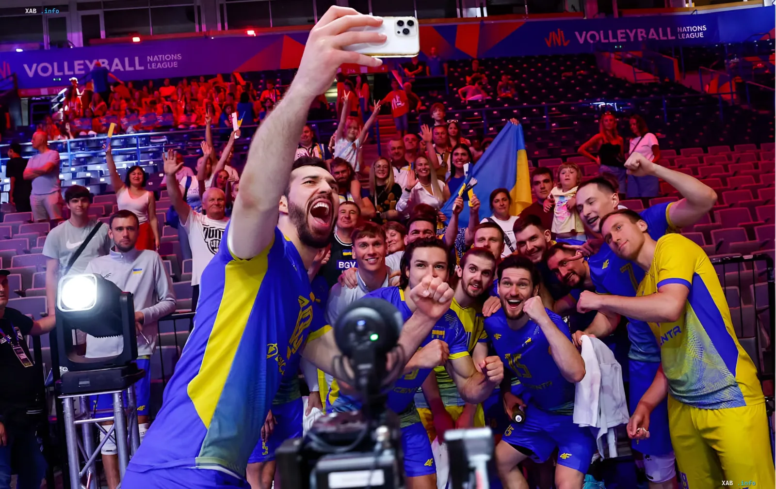 Ukraine volleyball team celebrates victory over Germany in VNL, taking a group selfie with fans