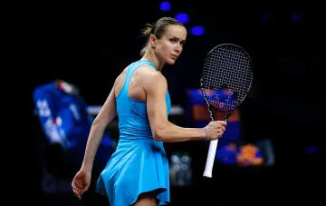 Ukrainian tennis player in blue dress with racket at Cincinnati tournament, ready for match before US Open