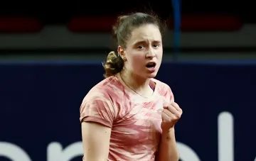Veronika Podrez celebrates her victory after advancing to the main draw in Prague, clenching her fist in emotion