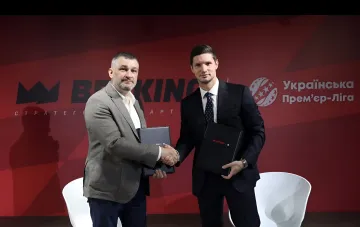 Рукопожатие представителей BETKING и Украинской Премьер-Лиги на фоне логотипов брендов — символический момент подписания стратегического партнерства