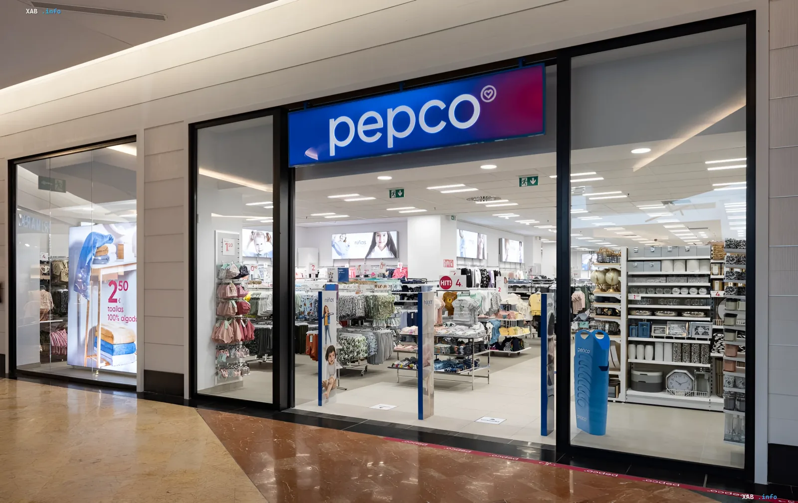 Storefront of Pepco in a shopping mall: entrance with signboard, display window featuring home textiles and household goods