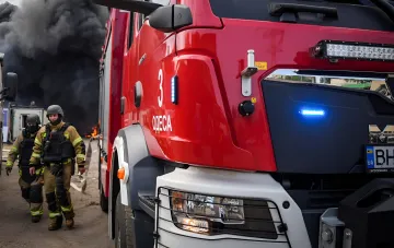 Firefighters in Odesa extinguishing fire after missile-drone strike: smoke, rescuers and fire truck with 'ODESA' inscription