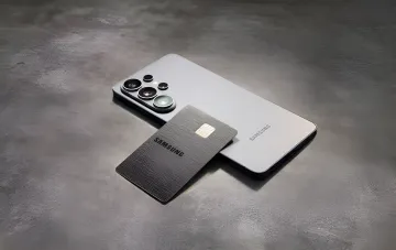 Black Samsung Galaxy Card credit card rests on a white Samsung Galaxy S23 Ultra smartphone, symbolizing up to 5% cashback on brand tech