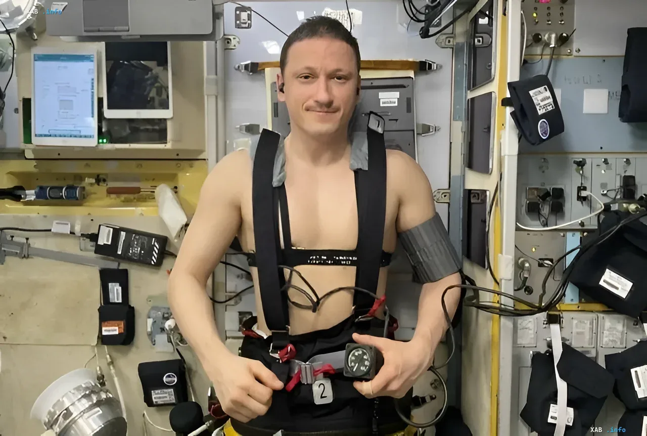Astronaut in a supportive medical harness aboard the ISS preparing for return to Earth after Soyuz MS-28 mission
