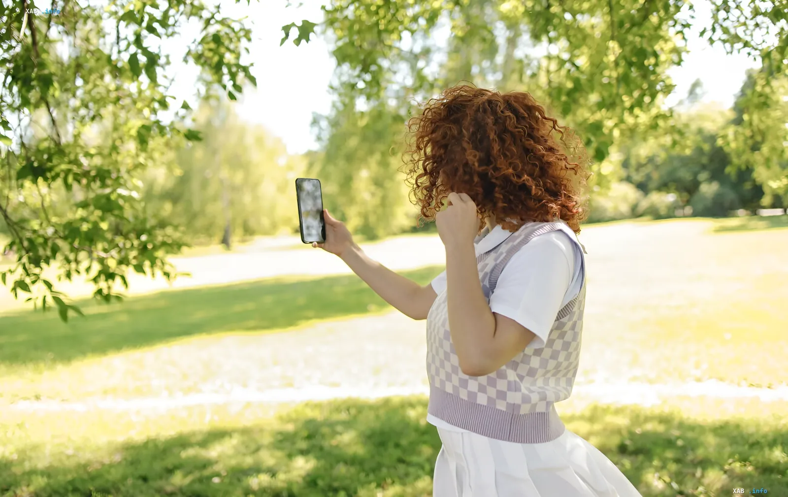 Fraun macht Selfie-Video mit Smartphone im Park, illustriert neuen Google-Login über kurzes Video