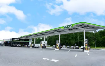Modern OKKO gas station with a multifunctional service hub where cars are refueled and receive additional services