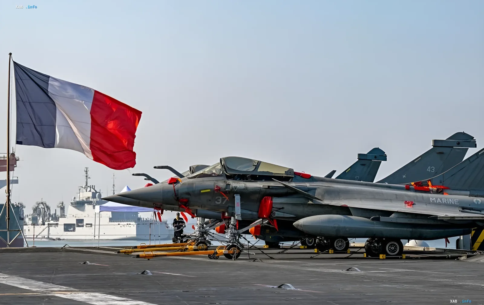French Rafale fighter jet on an aircraft carrier deck under the French flag: symbol of Paris's nuclear umbrella
