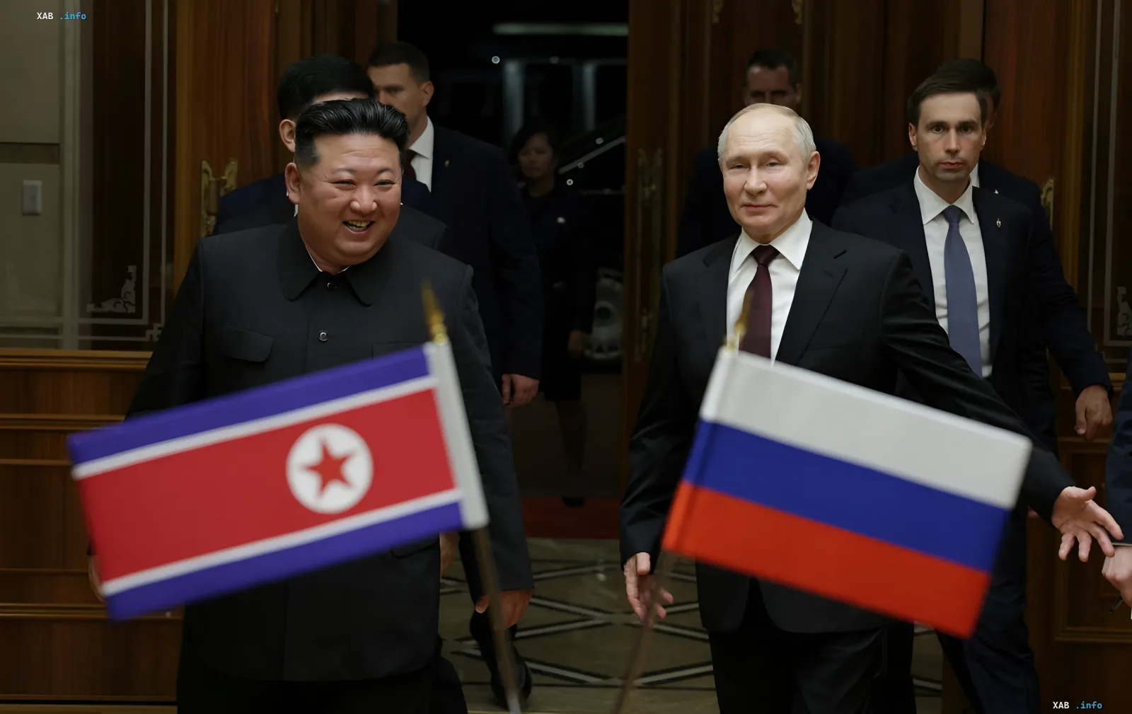 Vladimir Putin and Kim Jong Un with flags of Russia and North Korea, illustrating cooperation in the context of North Korean missile use