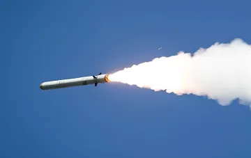 Ракета Х-101 в полете: дымный след на фоне голубого неба, иллюстрирующий тему экспертизы обломков в Польше