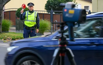 German police officer stopping a car using a radar detector on a dangerous road in Europe