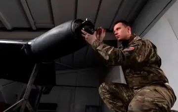 Russian soldier installing optical system on Geran-4 Seeker drone to evade air defense systems